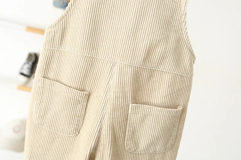 Close up of the cream corderoy overalls showing the back pockets of these boys pants.