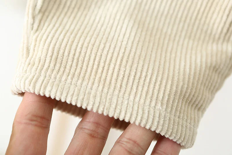 Close up of the pant cuff of the corderoy overalls for toddlers.