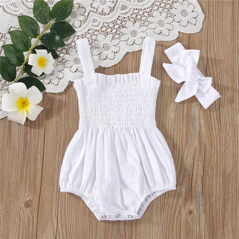 White infant romper with elastic straps at the shoulder a snap bottom and an elastic top with a bow.