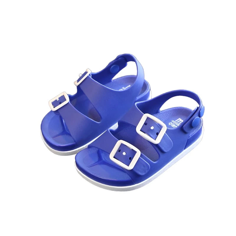 Blue waterproof kids sandals with two straps on the top with buckles and a strap on the heal with snaps.