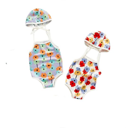 Infant bathing suit with floer graphics and a hat shown in both colors, white aand lilac