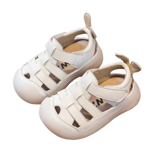White leather strap sandals with a velcro closure bor babies and toddlers.