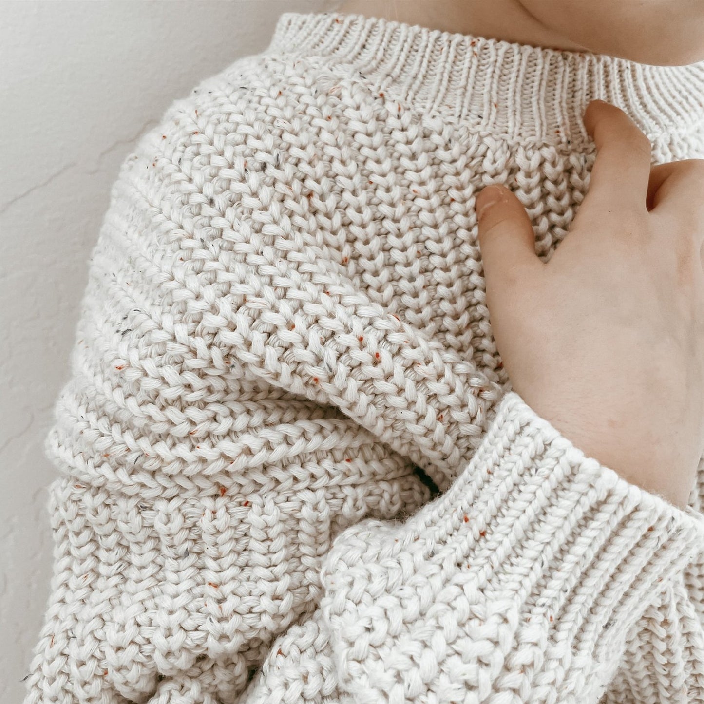 Bay wearing a chunky knitted sweater