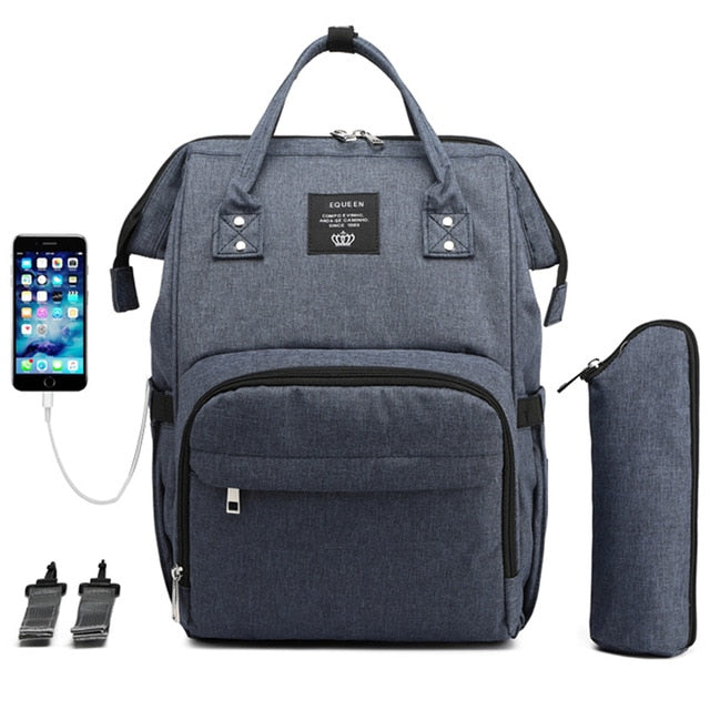 Carbon black diaper bag and backpack with an insulated waterbottle pouch, a USB charger for your phone and multiple pockets.