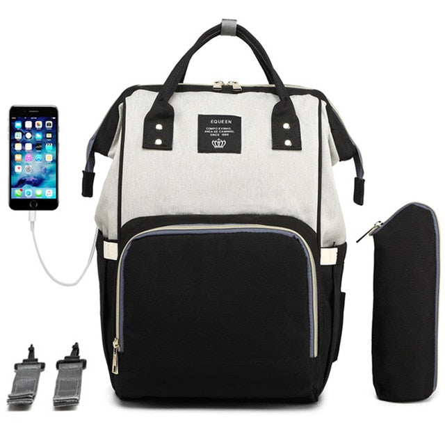 Black and white diaper bag and backpack with an insulated waterbottle pouch, a USB charger for your phone and multiple pockets.