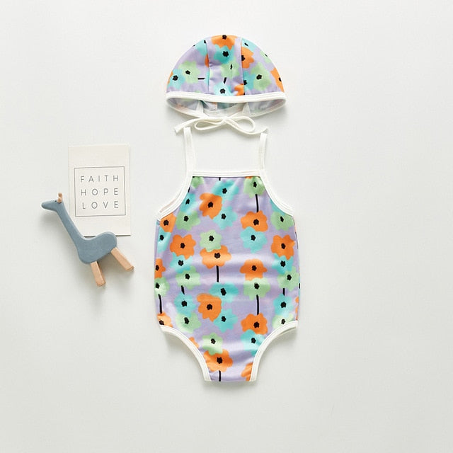 Lilac infant bathing suite with orange blue and green flowers. Infant bathing suit with floer graphics and a hat.