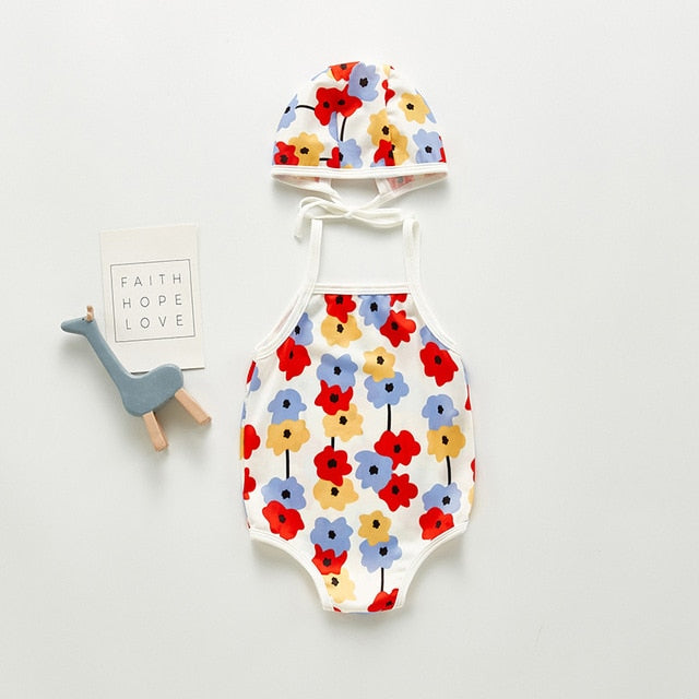 White bathing suite shown with red and lilac and yellow. Infant bathing suit with floer graphics and a hat.
