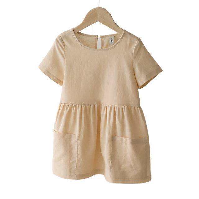 Cream short sleeved girls linen dress with front pockets.