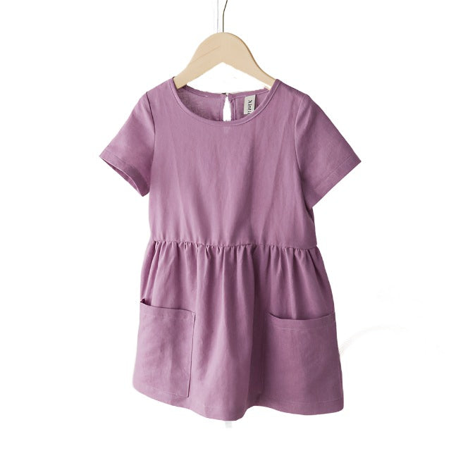 Lilac short sleeved girls linen dress with front pockets.