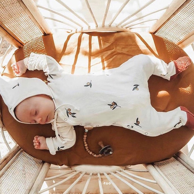 Ivory Infant sleeper with matching hat, with a flower graphic