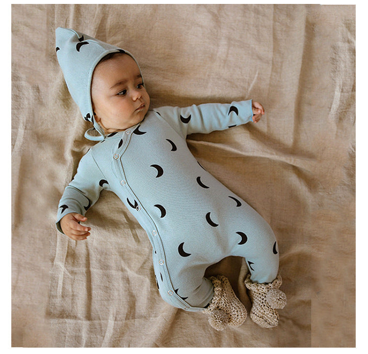 baby wearing a blue Infant sleeper with matching hat, with a moon graphic