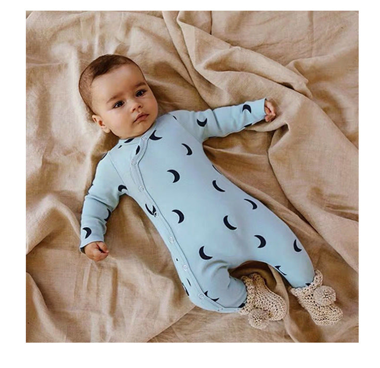 baby wearing a blue Ivory Infant sleeper with matching hat, with a fmoon graphic.