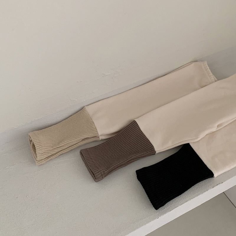 beige leggings with different colored double ribbing at the cuff.
