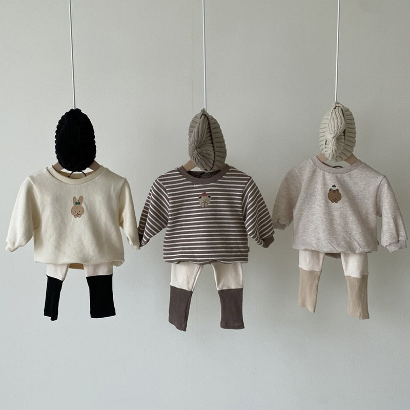 beige leggings with different colored double ribbing at the cuff.  with matching sweaters