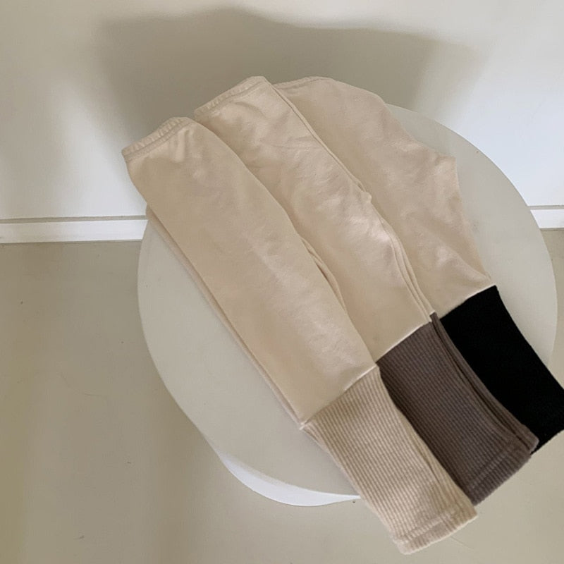 beige leggings with different colored double ribbing at the cuff.