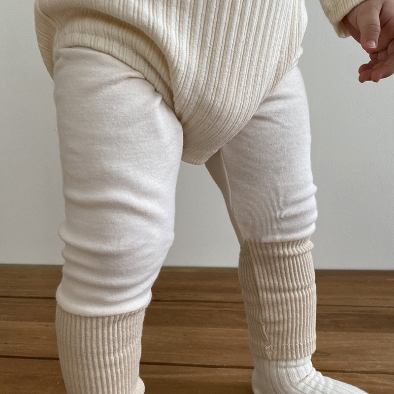 A child wearing beige tights with double ribbing at the bottom. C