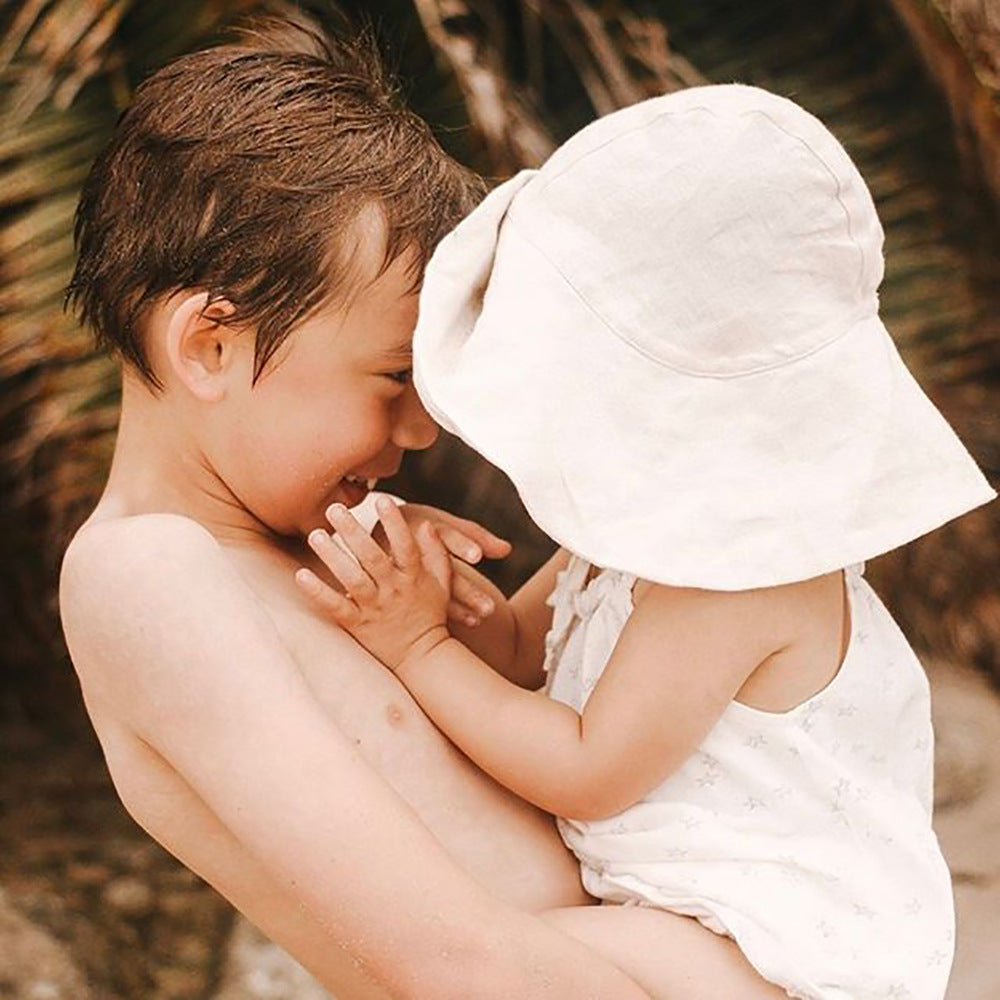 Baby wearing a White newborn baby summer hat