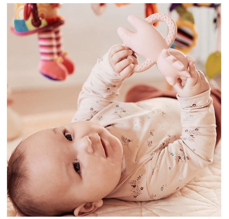 Baby playing with toy wearing 2 Piece set, long sleeved onesie with side and bottom snaps and leggings with berry pattern.
