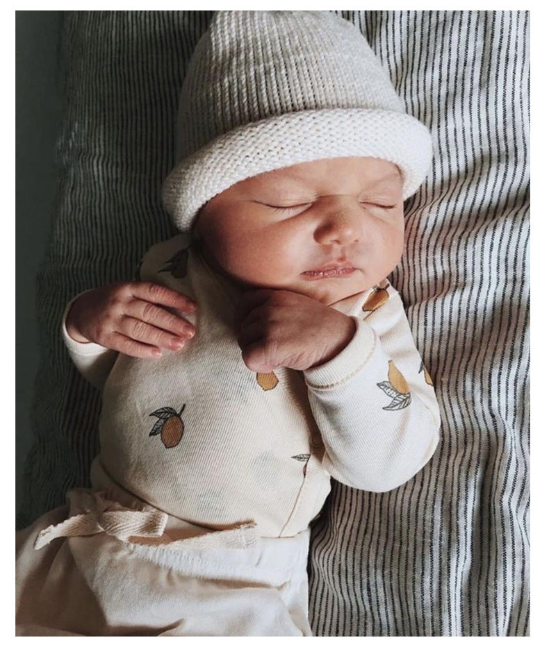 Baby wearing a long sleeved bodysuit with lemon graphics