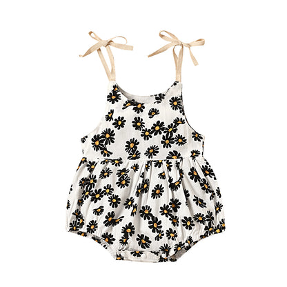 Cute infant romper for summer in 3 styles, pink qnd white. Ties at the shoulder and snaps at the bottom.  white with black flowers that are yellow in the middle