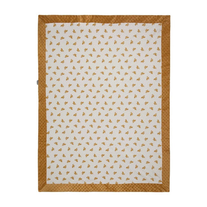 Kids toddler blanket in warm or cool in a burnt umber color on one side and a light color with flwer graphics on the other with a boarder. 