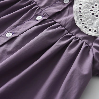 button up back of a purple girls dress. 