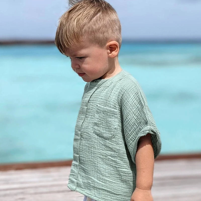 child wearing short sleeved muslim 100% cotton shirt for 4-10 year olds. 