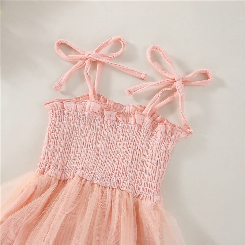 Pink Infant Blue bodysuit with ties at the shoulder, snap bottom and a tulle skirt. 