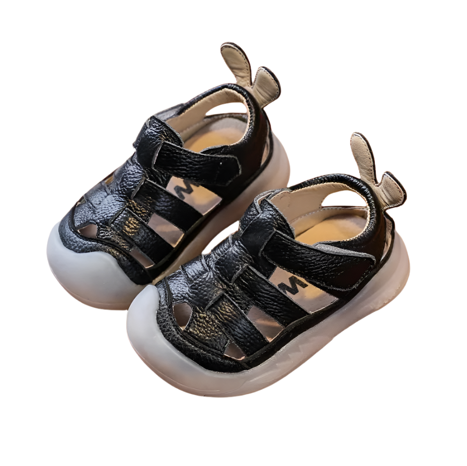 Black  leather strap sandals with a velcro closure bor babies and toddlers. 