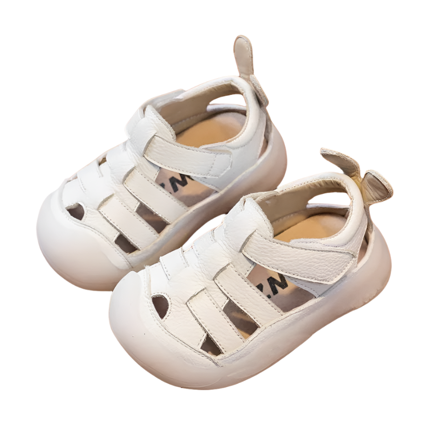 White leather strap sandals with a velcro closure bor babies and toddlers. 