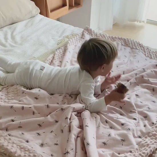 Video of child sleeping with a cute crib blanket. 