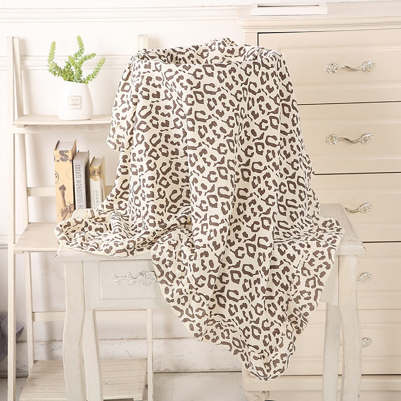 Leopard print organic cotton recieving blanket with ruffles in the edge. 