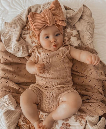 Infant knitted camisol bodysuit and shorts in beige.