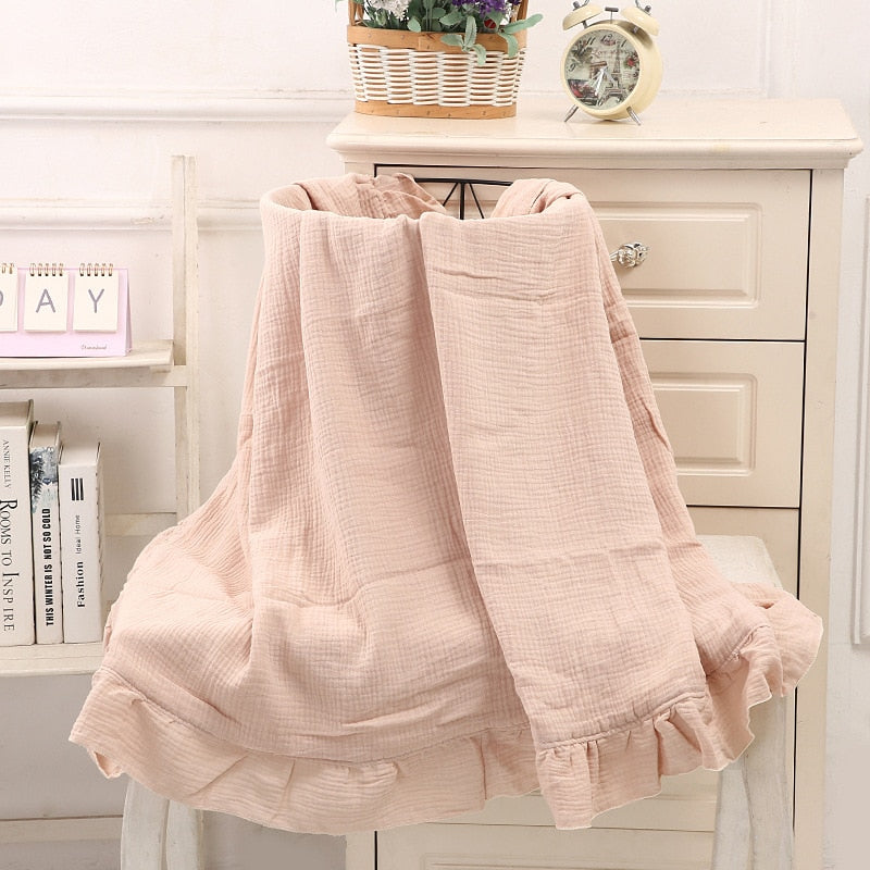 peach organic cotton recieving blanket with ruffles in the edge. 