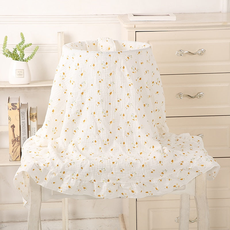 white with tiny yellow flowers organic cotton recieving blanket with ruffles in the edge. 