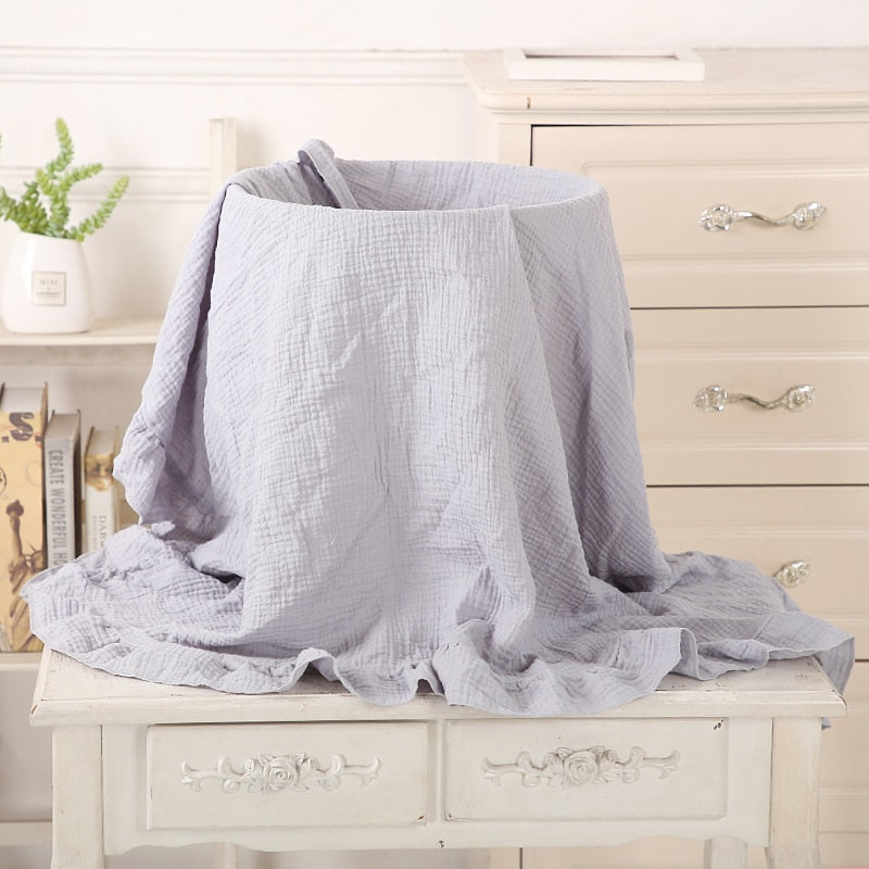 greyish organic cotton recieving blanket with ruffles in the edge. 