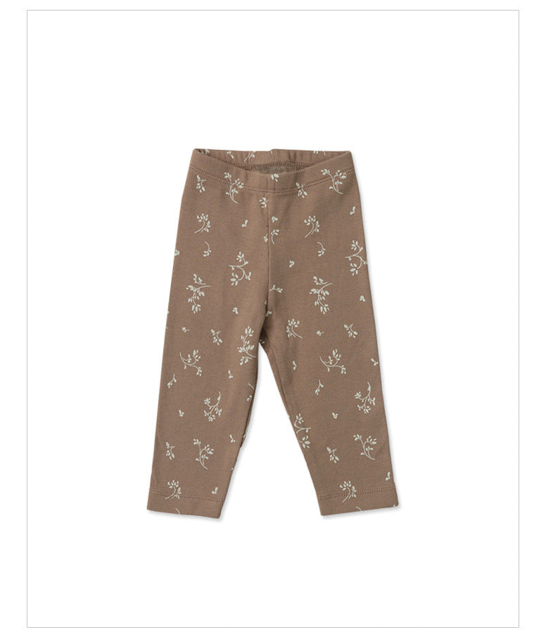 mushroom colored baby pants with small white flower graphics
