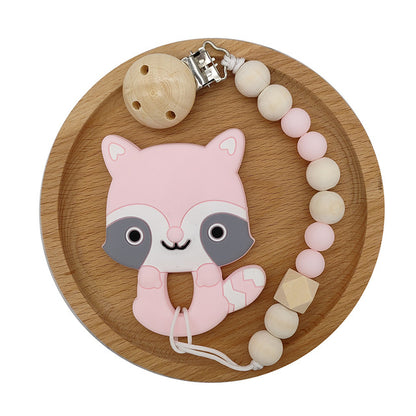Pink Raccoon Silicone and Wood Pacifier Clip and teether set in wooden circular tray