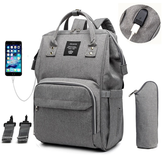 Soft grey diaper bag and backpack with an insulated waterbottle pouch, a USB charger for your phone and multiple pockets. 