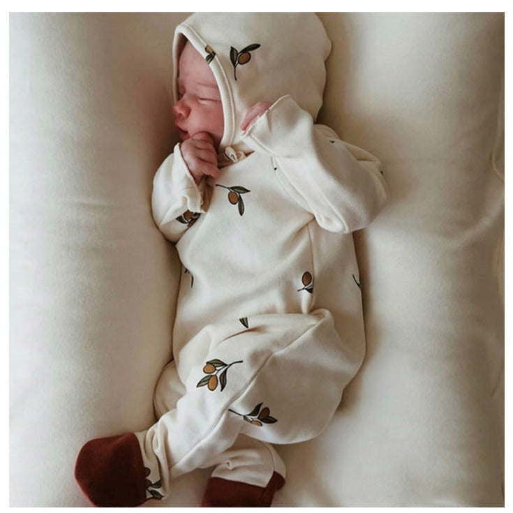 infant wearing Ivory Infant sleeper with matching hat, with a flower graphic