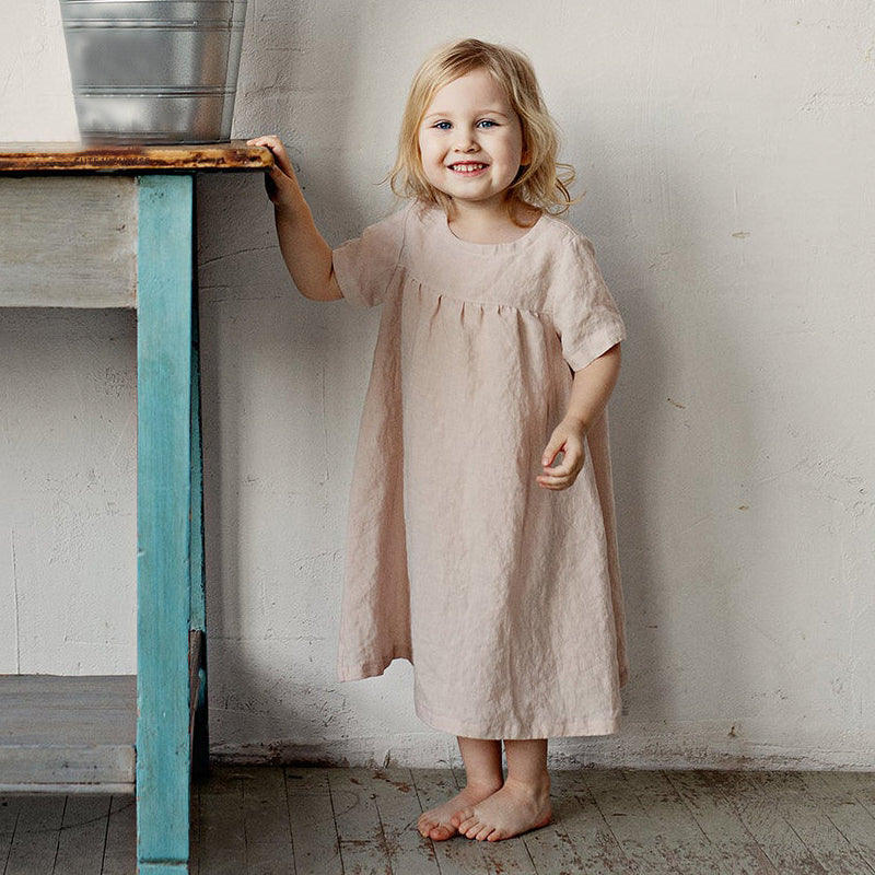 Smiling toddler wearing classic linin dress