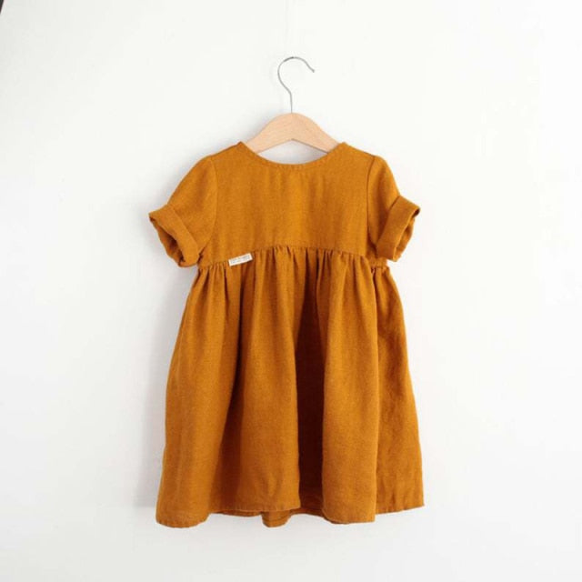 Orange girls linnen summer dress with an o neck, kalf length gathered skirt and rolled up short sleeves. 
