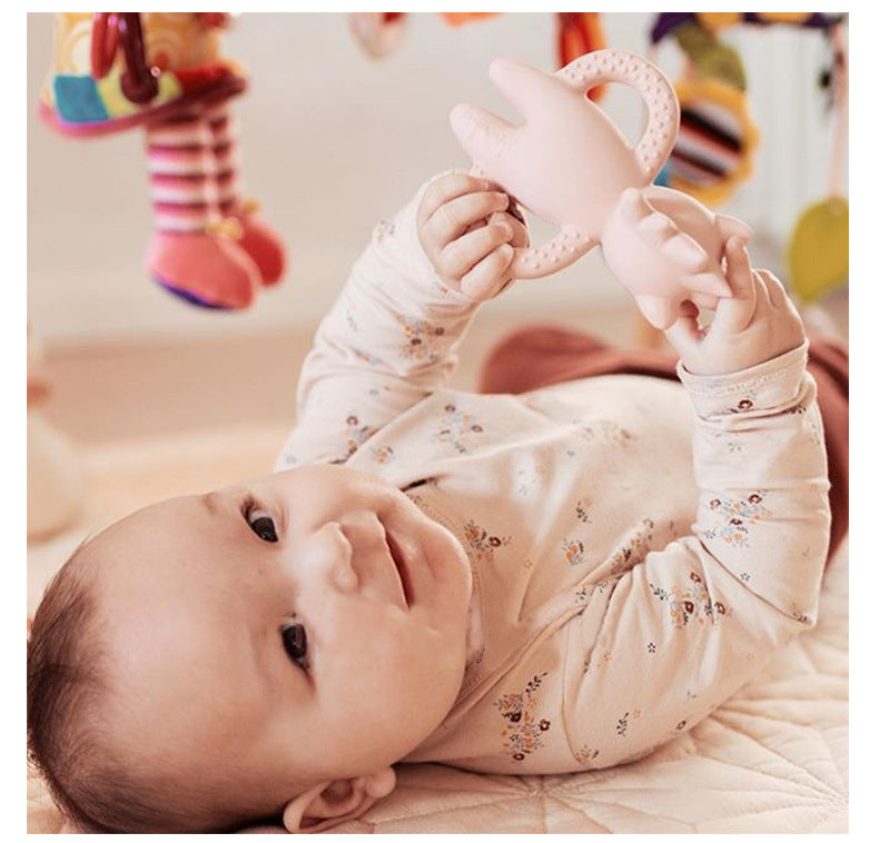 Baby playing with toy wearing 2 Piece set, long sleeved onesie with side and bottom snaps and leggings with berry pattern. 